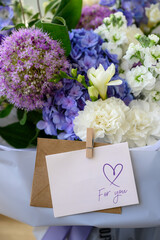 love you text, greeting card paper note. Beautiful bouquet of mixed flowers from hydrangea. Valentine's Day and love concept