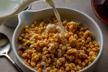 Milk and granola.
Breakfast image.

