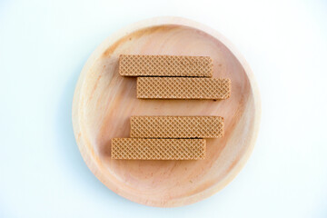 Chocolate waffles on wooden plate isolated on white background. Crispy snack dessert. Food Photography Concept