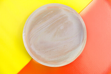 brown wooden plate texture isolated on orange and yellow background. Crispy snack dessert. Food Photography Concept