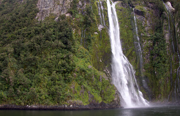 Waterfalls cascading into Milford Sound in New Zealand