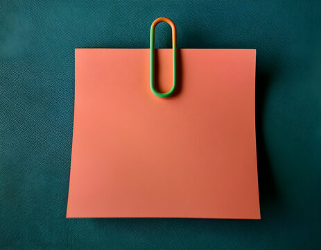 a pink note paper with a green and orange clip, highlighting the intricate details and textures.