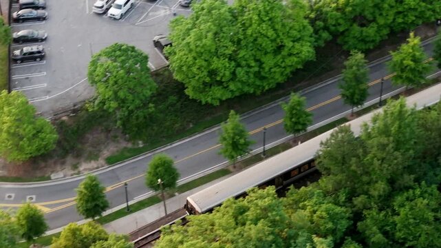 Drone shot of Atlanta metro rail crossing through Georgia State Route 400, T Harvey Mathis Parkway