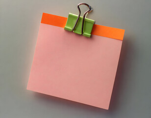 a pink note paper with a green and orange clip, giving it a nostalgic and charming feel.