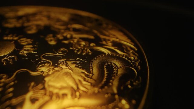 macro close up of golden plate with chinese art dragon rotate on black background