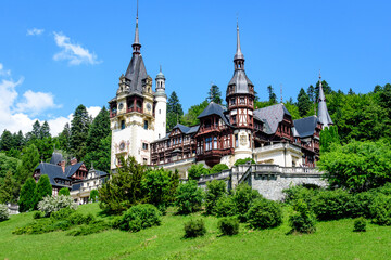 Beautiful neo-Renaissance building of Peles Castle (Castelul Peles) near Bucegi Mountains (Muntii Bucegi) in a sunny summer day in Sinaia town, Romania .