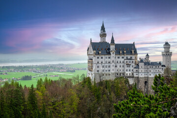 Golden hour casts a magical glow on ancient stone fortress perched atop a hill, a breathtaking European landmark