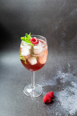 Icetea with raspberry and mint on dark background