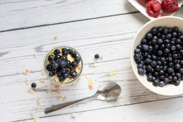Granola with yogurt and berries in a jar. Breakfast parfait with muesli, yoghurt and blueberries