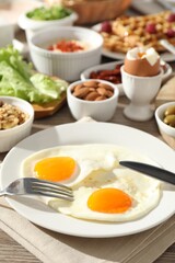 Different meals served for breakfast on wooden table