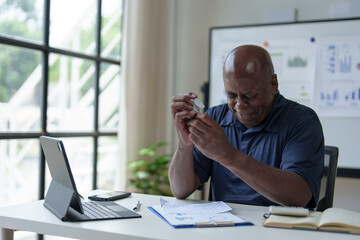 Naklejka premium African American adult businessman upset. Depression. Senior man working in office with paperwork. Dissatisfied with the financial results of an investment malfunction Office syndrome concept.
