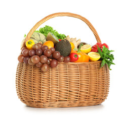 Many different fruits and vegetables in wicker basket isolated on white