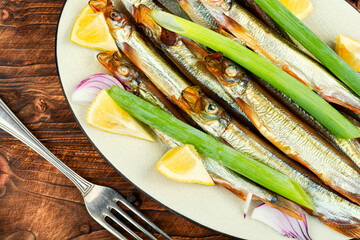 Smoked capelin fish with lemon