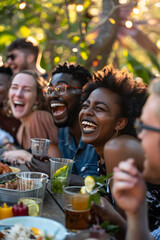 Obraz premium Diverse group of friends laughing together at a backyard barbecue 