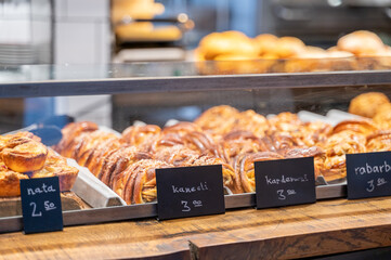 Swedish cinnamon and cardamom buns are displayed in bakery showcase with price tags