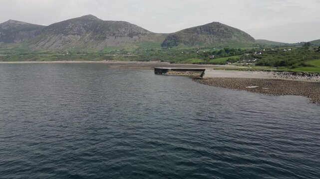 Aerial video over the coastline in Trefor Bay United Kingdom