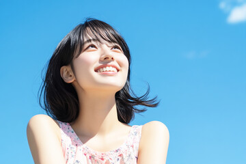 Japanese woman smile enjoying sun during summer vacation, mental health