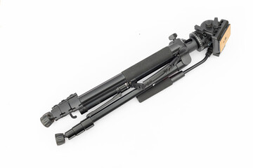 Modern tripod for camera and phone folded isolated on white background