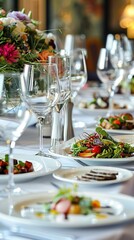 A beautifully set dining table displays gourmet dishes and fine glassware, adorned with vibrant floral arrangements