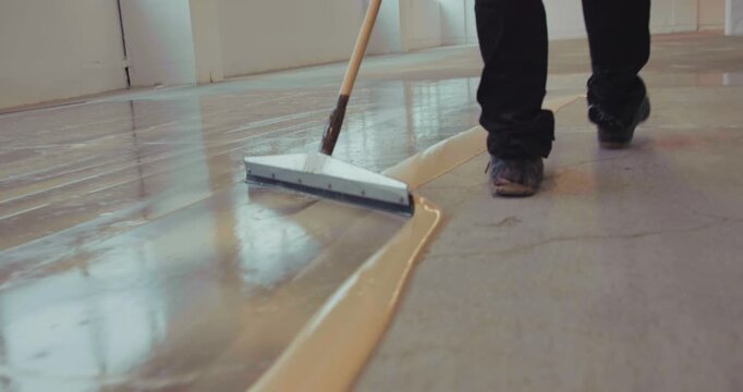 Industrial Epoxy Coatings for Concrete Protection, Sealing, and Coating by Warehouse Worker