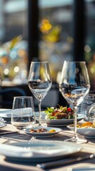 A beautifully arranged table showcases gourmet dishes and fine glassware during a sunset dining experience