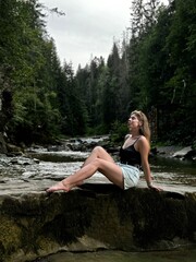 Fototapeta premium person sitting on the rocks