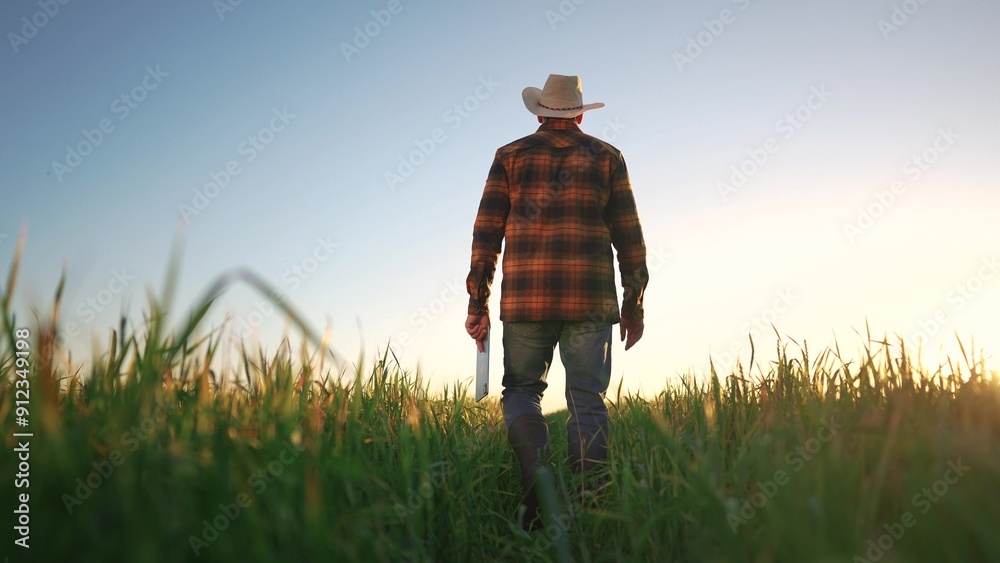 Sticker farmer silhouette at sunset with a tablet working in a wheat field. agriculture business farm concep