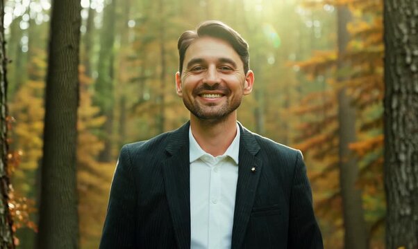 Environmental portrait video of a pleased man in his 40s wearing a classic blazer against a forest background
