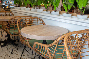 A table with wicker chairs in cafe.