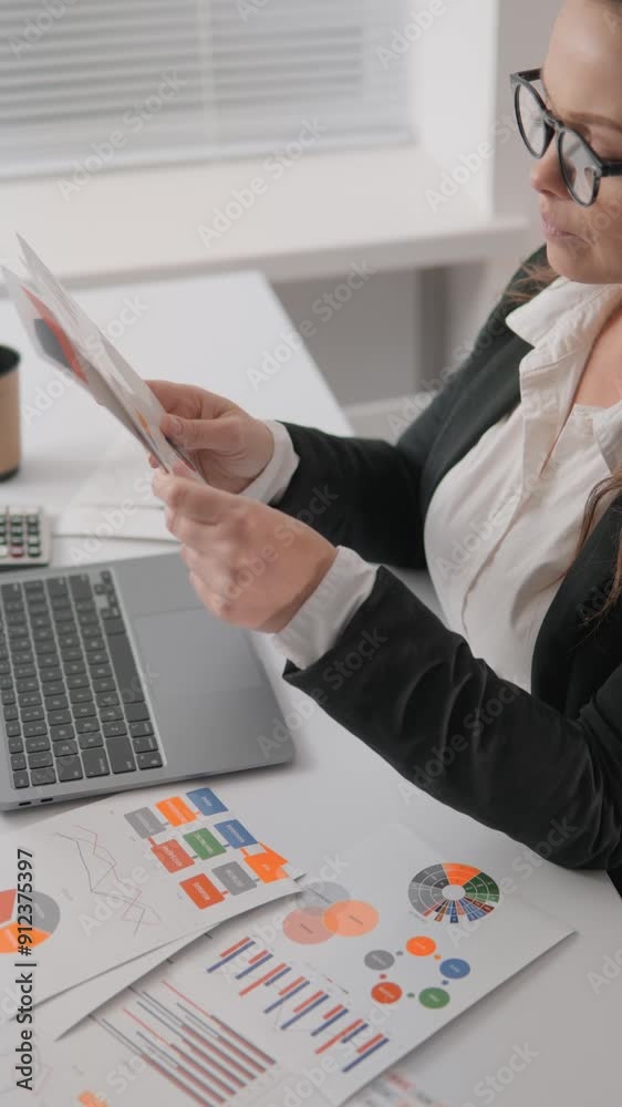 Poster conducting analysis and reviewing reports in a professional business setting is crucial for achievin