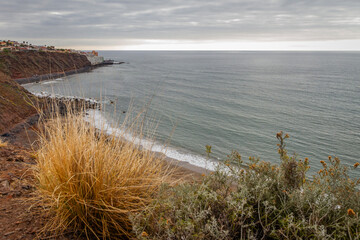 Seascape. Calm sea. Ocean views from the cliff. Sunset at sea. Views of the village of Bajamar and natural pools. Tenerife, Bajamar, Canary Islands.