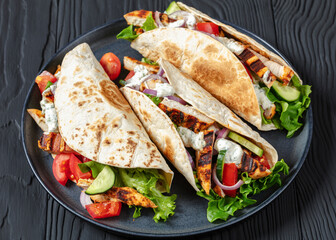 grilled chicken street tacos on a dark plate