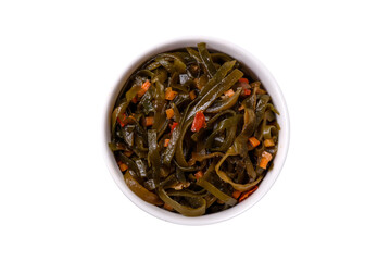 Delicious marinated seaweed with paprika, spices and salt on a dark concrete background