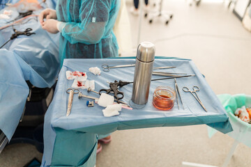Surgical instruments in the operating room. tweezers, scalpel, needle holder, rasps on the...