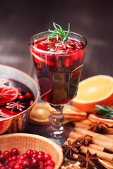 Christmas drink - mulled wine with slices of orange, cinnamon stick, star anise, rosemary and cranberries close up. Food photography
