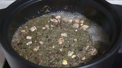 Boiling traditional Chinese medicine. Chinese herbs Chinese herbal medicine derived from nature for example, roots, leaves in boil in the pot.