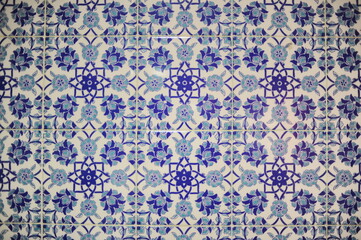 Traditional Turkish ceramic tiles, closeup photo of decorative, vintage, blue, cyan, historic tiles on the wall in Türkiye (Turkey)