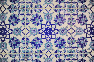 Traditional Turkish ceramic tiles, closeup photo of decorative, vintage, blue, cyan, historic tiles on the wall in Türkiye (Turkey)