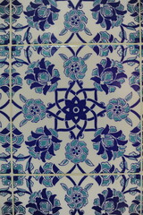 Traditional Turkish ceramic tiles, closeup photo of decorative, vintage, blue, cyan, historic tiles on the wall in Türkiye (Turkey)