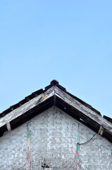 The roof of an old house made of wood and clay tiles