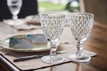 A table setting with two wine glasses and a name card for a guest