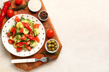 Plate of tasty Potato Salad with vegetables and ingredients on light background