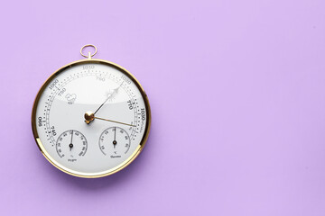 Aneroid barometer on purple background