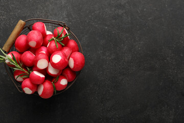 Basket with fresh radish on dark background