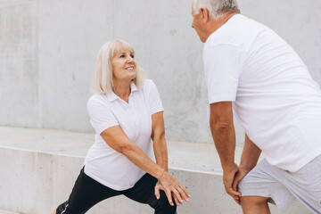 Senior Couple Exercising Together Outdoors in Matching Sportswear