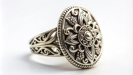 Naklejka premium Antique-inspired silver tribal ring with intricate filigree patterns and ornate details on a clean, minimalist white studio background.