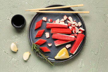 Plate with tasty crab sticks and sauce on light background © Pixel-Shot