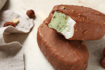 Tasty chocolate covered ice cream on light background, closeup