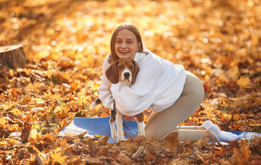 Embracing the animal. Woman is with her cute dog in the autumn forest