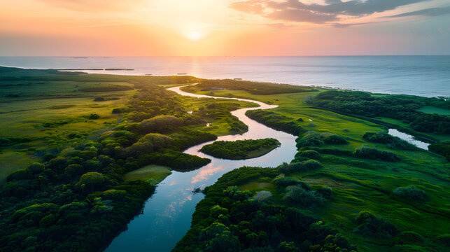 a drone of a winding river in a green setting up to the ocean lagoon to the right of the photo which can be seen widely
